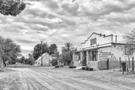 VOSBURG, SOUTH AFRICA, SEPTEMBER 1, 2018: A street scene, with a coffee shop and craft shop, in Vosburg in the Northern Cape Province. Monochromeのeditorial素材