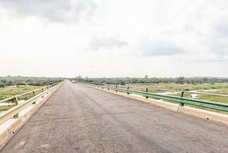 KRUGER NATIONAL PARK, SOUTH AFRICA - MAY 7, 2019: Bridge on road H1-5 over the Olifants River. A vehicle and tourists are visibleのeditorial素材