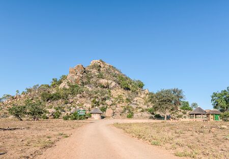 KRUGER NATIONAL PARK, SOUTH AFRICA - MAY 9, 2019: A view of the Masorini Picnic Site. A hill and buildings are visibleのeditorial素材