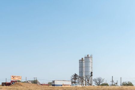 PHALABORWA, SOUTH AFRICA - MAY 18, 2019: A concrete ready mix business near Phalaborwa. Equipment and vehicles are visibleのeditorial素材