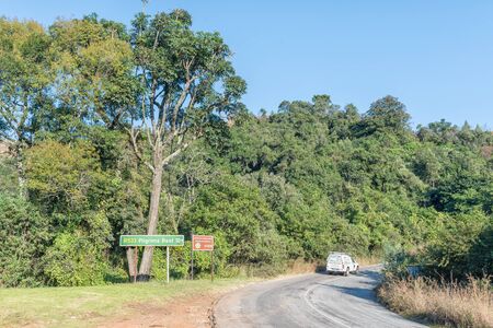 GRASKOP, SOUTH AFRICA - MAY 21, 2019: The landscape on road R533 between Graskop and Pilgrims Rest in Mpumalanga. Signs and a vehicle are visibleのeditorial素材