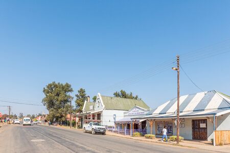 MACHADODORP, SOUTH AFRICA - MAY 22, 2019: A street scene, with businesses and vehicles, in Machadodorp in Mpumalangaのeditorial素材