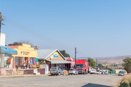 MACHADODORP, SOUTH AFRICA - MAY 22, 2019: A street scene, with businesses and vehicles, in...