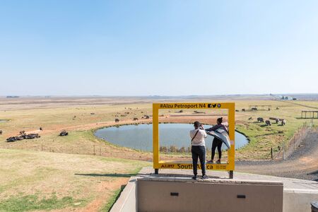ALZU, SOUTH AFRICA - MAY 22, 2019: Tourists at the photography frame at Alzu Petruport next to road N4 between Belfast and Middelburg in Mpumalanga. Wild animals are visibleのeditorial素材