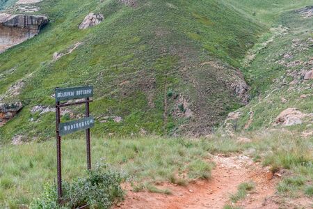 Sign on top of the Brandwag buttress at Golden Gate. The trail leading down to the hotel is visibleの写真素材