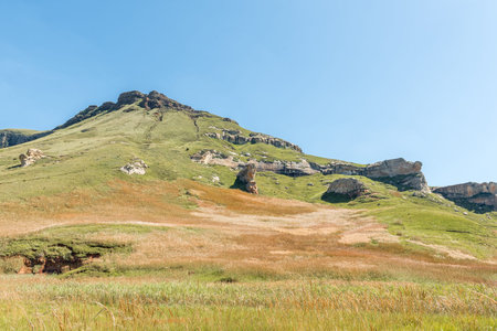 A mountain landscape, with rock formations and golden grass fields, in Golden Gateの写真素材