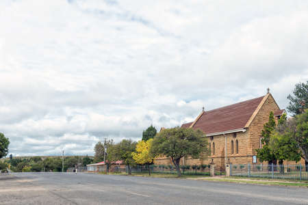 HARRISMITH, SOUTH AFRICA - MARCH 16, 2020:  A street scene, with the St John the Baptist Anglican Church, in Harrismith in the Free State Province. A person is visibleのeditorial素材