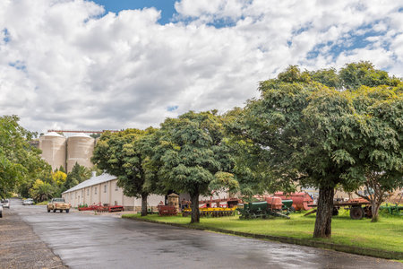 FICKSBURG, SOUTH AFRICA - MARCH 20, 2020: A street scene, with agriculture equipment, vehicles and silos, in Ficksburgのeditorial素材