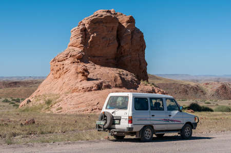 DAMARALAND, NAMIBIA - MAY 29, 2011: A rock formation next to road C39 in Damaraland, Namibia. A vehicle is visibleのeditorial素材