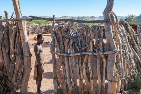 DAMARALAND, NAMIBIA - MAY 30, 2011: A Damara man in traditional clothes is visible at the entrance...