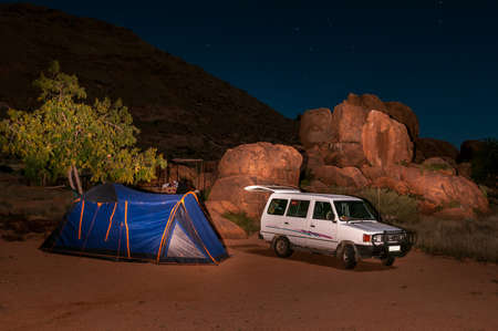 KOIIMASIS, NAMIBIA - JUNE 12, 2011: Night camping scene at Ranch Koiimasis in southern Namibia. A vehicle and tent are visibleのeditorial素材