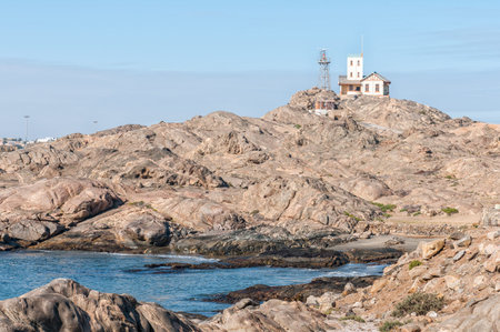 LUDERITZ, NAMIBIA - JUNE 15, 2011: View of the historic, old, lighthouse on Shark Island, now a...