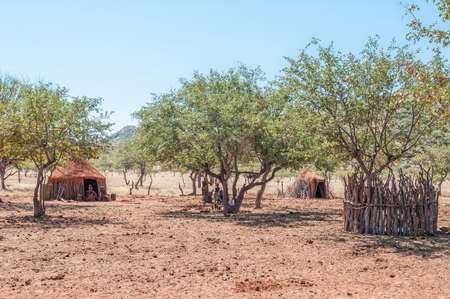 EPUPA, NAMIBIA - MAY 27, 2011: A Himba village near Epupa. Traditional huts and people are visibleのeditorial素材