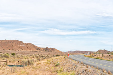 Vehicles are visible on road N1 between Richmond and Three Sisters in the Northern Cape Karoo. A...