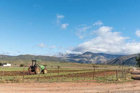 AMALIENSTEIN, SOUTH AFRICA - APRIL 6, 2021: A tractor plowing a field at Amalienstein in the Western Cape Karooのeditorial素材