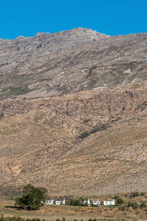 SEWEWEEKSPOORT, SOUTH AFRICA - APRIL 6, 2021: Farm worker houses at the foot of the Swartberg Mountains at Sandrivier farmのeditorial素材