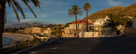 GORDONS BAY, SOUTH AFRICA - APRIL 12, 2021: Panoramic sunset view of  Gordons Bay in the Western Cape Province. The beach and buildings are visibleのeditorial素材
