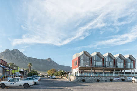 KLEINMOND, SOUTH AFRICA - APRIL 12, 2021: Restaurants at the waterfront at the harbour in Kleinmond in the Western Cape Province. Vehicles are visibleのeditorial素材
