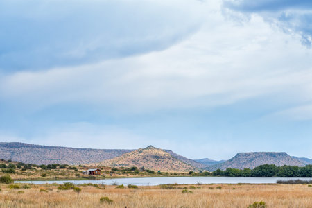 JAMESTOWN, SOUTH AFRICA - APRIL 22, 2021: A dam and house on a farm on road D2679 in the Eastern...