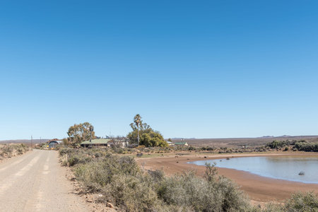 FRASERBURG, SOUTH AFRICA - SEP 3, 2022: Road landscape at Eselfontein Guest Farm on the historic Postal Route between Fraserburg and Sutherland in the Northern Cape Karooのeditorial素材