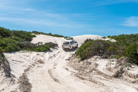 Struisbaai, South Africa - Sep 22, 2022: A pick-up truck is visible on the road to the Struisbaai...