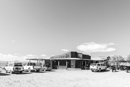 Tankwa, South Africa - Sep 4, 2022: Tankwa Road Stall next to road R355 in the Tankwa Karoo of the Western Cape Province. Vehicles are visible. Monochromeのeditorial素材