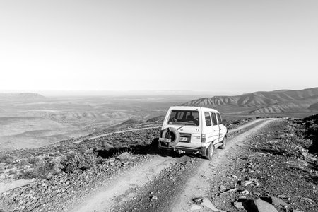 Sutherland, South Africa - Sep 4, 2022: A vehicle is visible on the Ouberg Pass near Sutherland in the Northern Cape Province.. Monochromeのeditorial素材