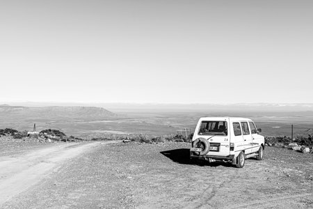 Sutherland, South Africa - Sep 4, 2022: Top of the Ouberg Pass near Sutherland in the Northern Cape Province. A vehicle is visible. Monochromeのeditorial素材