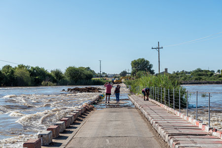 Kanoneiland, South Africa - Feb 25, 2023: The Eendrag bridge over the flooded Orange River at Kononeiland near Upington. People are visibleのeditorial素材