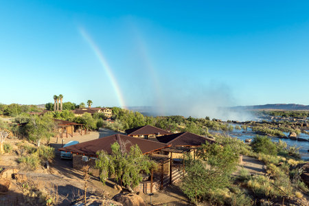 Augrabies National Park, South Africa - Feb 27, 2023: A double rainbow, caused by the spray of the Augrabies Falls. The rest camp is visibleのeditorial素材
