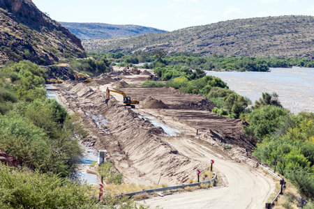 Boegoeberg Dam, South Africa - Feb 28 2023: Backhoe loaders clearing sand that blocked the...