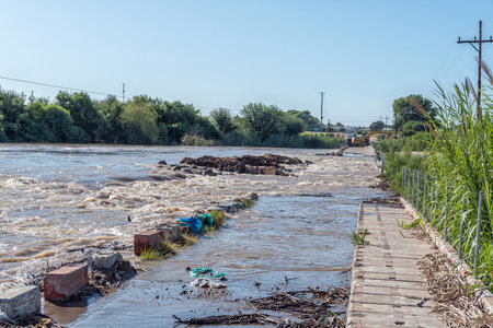 Kanoneiland, South Africa - Feb 25, 2023: The flooded Orange River flowing over Eendrag bridge at Kononeiland near Upingtonのeditorial素材