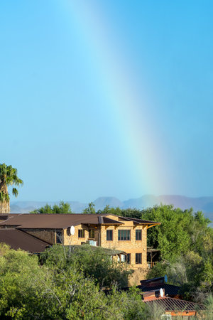 Augrabies National Park, South Africa - Feb 27, 2023: A rainbow, caused by the spray of the Augrabies Falls is visible above the restaurant and offices of the parkのeditorial素材
