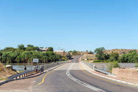 Keimoes, South Africa - Feb 28 2023:The first of three consecutive bridges crossing the flooded Orange River at Keimoes. People are visibleのeditorial素材