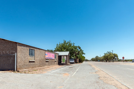 Groblershoop, South Africa - Feb 24, 2023: A street scene, with a business and vehicles, in Groblershoop in the Northern Cape Provinceのeditorial素材