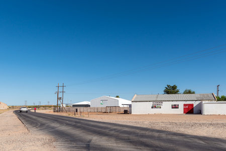 Kanoneiland, South Africa - Feb 25, 2023: A road scene, with businesses, near Kononeiland. Power infrastructure is visibleのeditorial素材