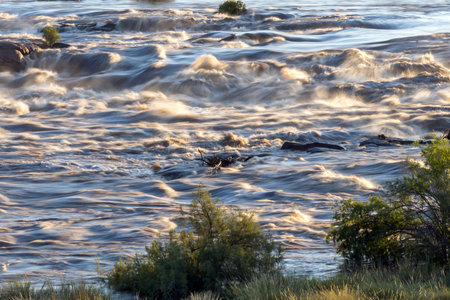 Rapids in the Orange River above the main Augrabies waterfall. The river is in floodの写真素材