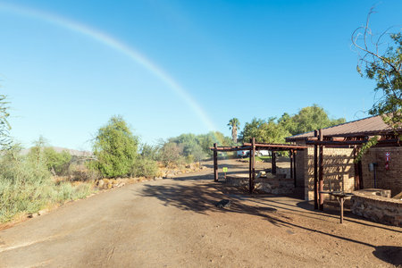 Augrabies National Park, South Africa - Feb 26, 2023: A chalet in the Augrabies Falls National Park. A rainbow is visible in the spray of the fallsのeditorial素材