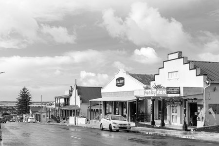 Bredasdorp, South Africa - Sep 23, 2022: A street scene, with businesses, in Bredasdorp in the Western Cape Province. Vehicles are visible. Monochromeのeditorial素材