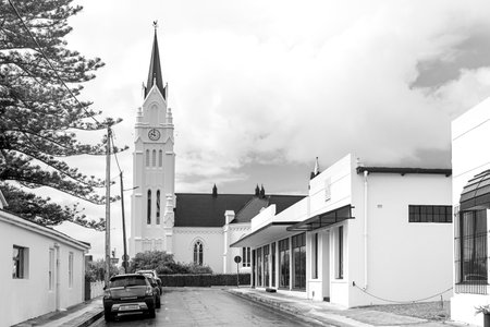 Bredasdorp, South Africa - Sep 23, 2022: A street scene, with the Dutch Reformed Church and historic buildings, in Bredasdorp in the Western Cape Province. Monochromeのeditorial素材