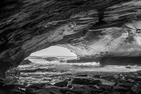 Inside the Waenhuiskrans Cave near Arniston in the Western Cape Province. The Indian Ocean is visible. Monochromeの写真素材