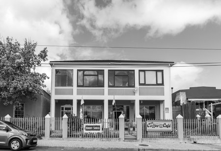Napier, South Africa - Sep 23, 2022: A street scene, with several businesses in an old house, in Napier in the Western Cape Province. Monochromeのeditorial素材