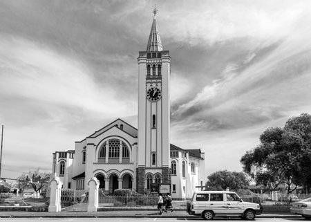 Riversdale, South Africa - Sep 24, 2022: A street scene, with the Dutch Reformed Church Riversdal, in Riverdale in the Western Cape Province People and vehicles are visible. Monochromeのeditorial素材