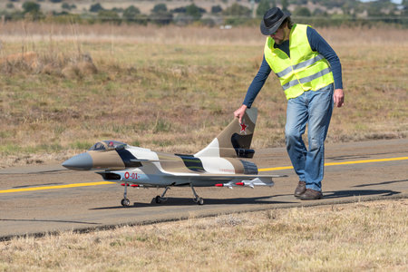Bloemfontein, South Africa - May 20, 2023: Person pushing a remote controlled jet aircraft on a taxiway at the Tempe Airport in Bloemfonteinのeditorial素材