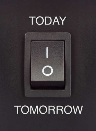 Black toggle switch on black surface - Today Tomorrowの写真素材