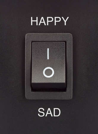 Happy or Sad black toggle switch on black surface positive negativeの写真素材