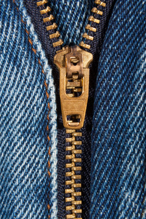Close up of denim jeans zip partly open