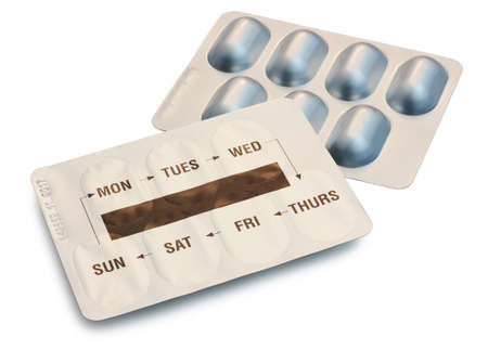 Two Blister Packets of Pills with days of the week printed on the pack isolated on white background with clipping pathの写真素材