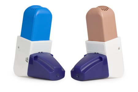 Blue and Brown Asthma Inhalers with caps isolated on white