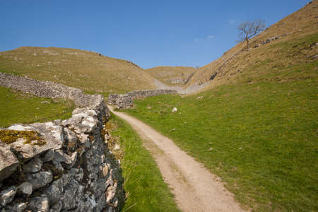 Path and dry stone wall in The Yorkshire Dales in Englandの写真素材